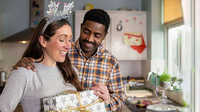Couple sharing wrapped holiday gift