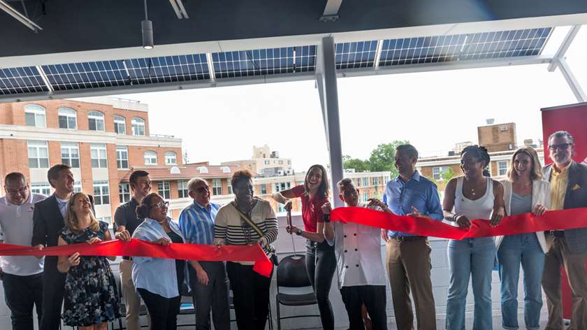 Staff from the Festival Center, Usource, New Columbia Solar, the DCSEU, and DOEE  cutting the ceromonial ribbon on a solar awning system.