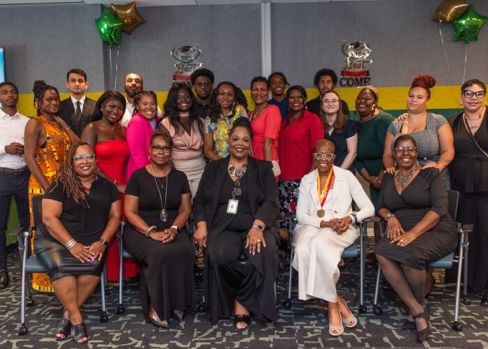 Group of DCSEU staff and Workforce Development Program externs posing at the program graduation ceremony.
