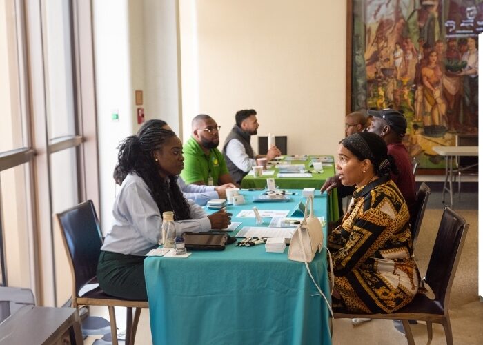 DCSEU staff members providing 1-on-1 meetings with customers at a tabling event.