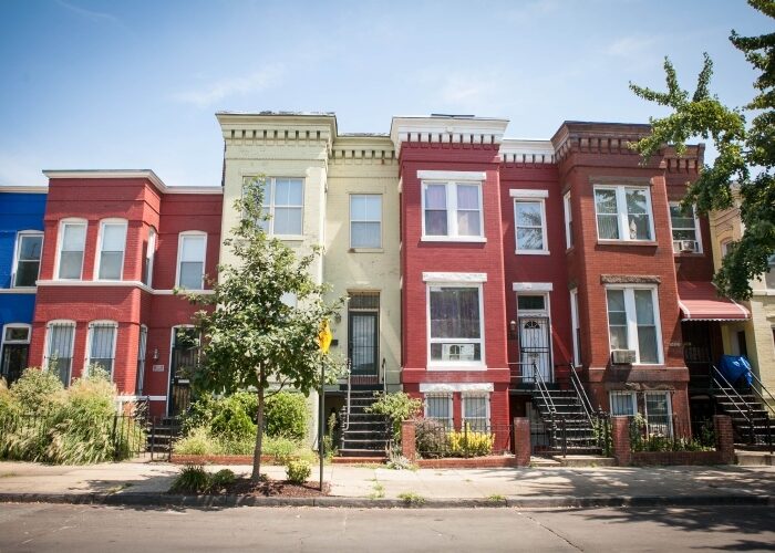 Colorful view of row homes in DC from the street.