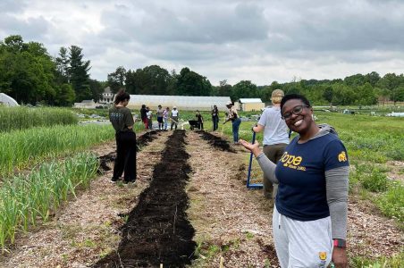 Yvonne Coles posing at OlaLekan Farm Community Day while volunteering and gardening.