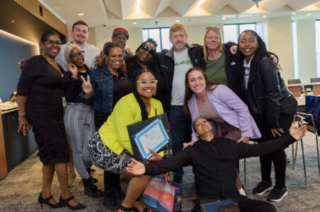 Group of Advanced Solar staff and program externs posing and smiling for the camera after the Workforce Development Program graduation.