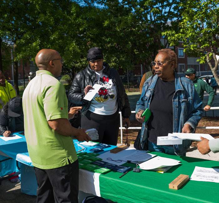 DOEE Solar for All staff member explaining how to become a community solar subscriber and receive complimentary gift cards to two Parkside residents.