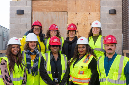 Group of DC SAFE staff in hardhats at the construction site of their new domestic violence shelter for women.