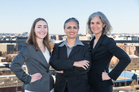The women of Energy Shrink. Kara, Smita, and Christie posing in front of the DC skyline with the Washington Monument visible in the background.