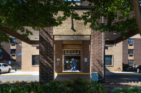 Clinician walking in the brick entrance of the Capitol City Rehabilitation and Healthcare Center.