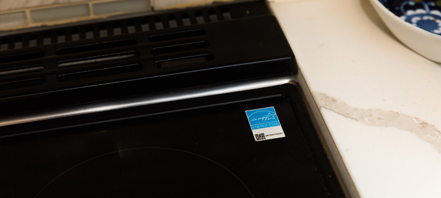 Close up of an induction stove with a visible ENERGY STAR sticker.