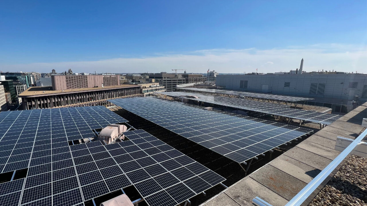 Rooftop solar array of Washington Square building with the downtown DC skyline in the background.