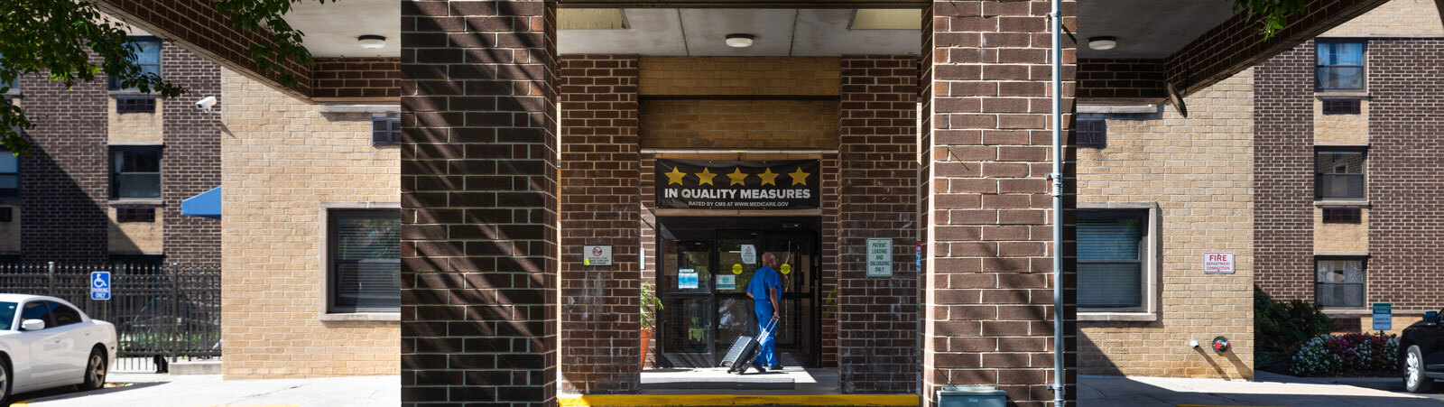 Clinician walking in the brick entrance of the Capitol City Rehabilitation and Healthcare Center.