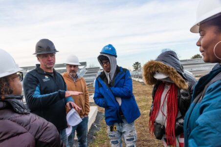 Neo Energy staff providing a tour of solar site to KIPP students.