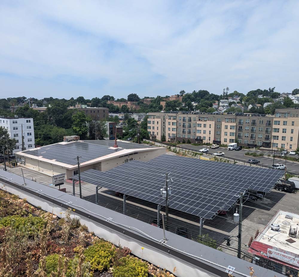 Aerial view of the House of Praise rooftop and carport community solar arrays.