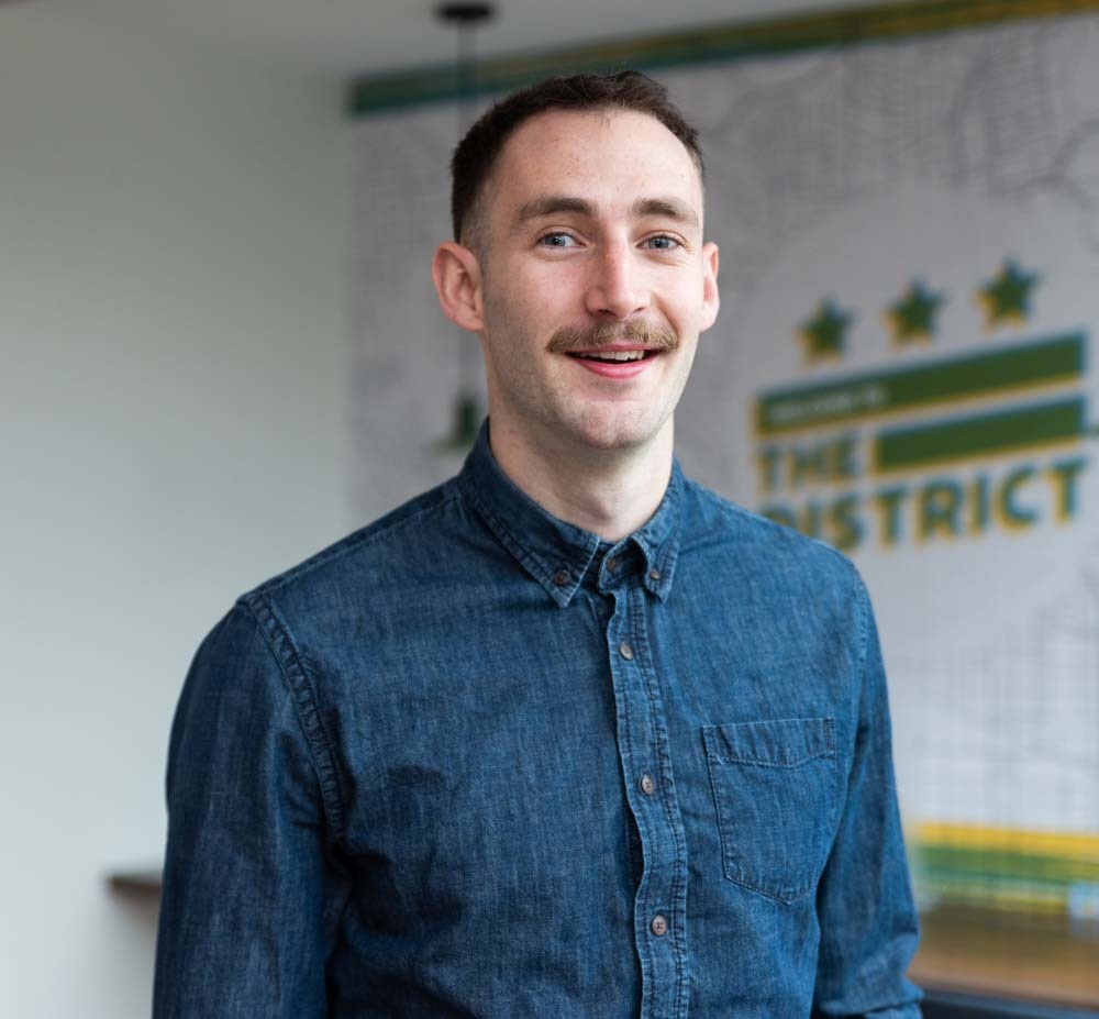 Portrait of Jack Sullivan smiling in an office setting.