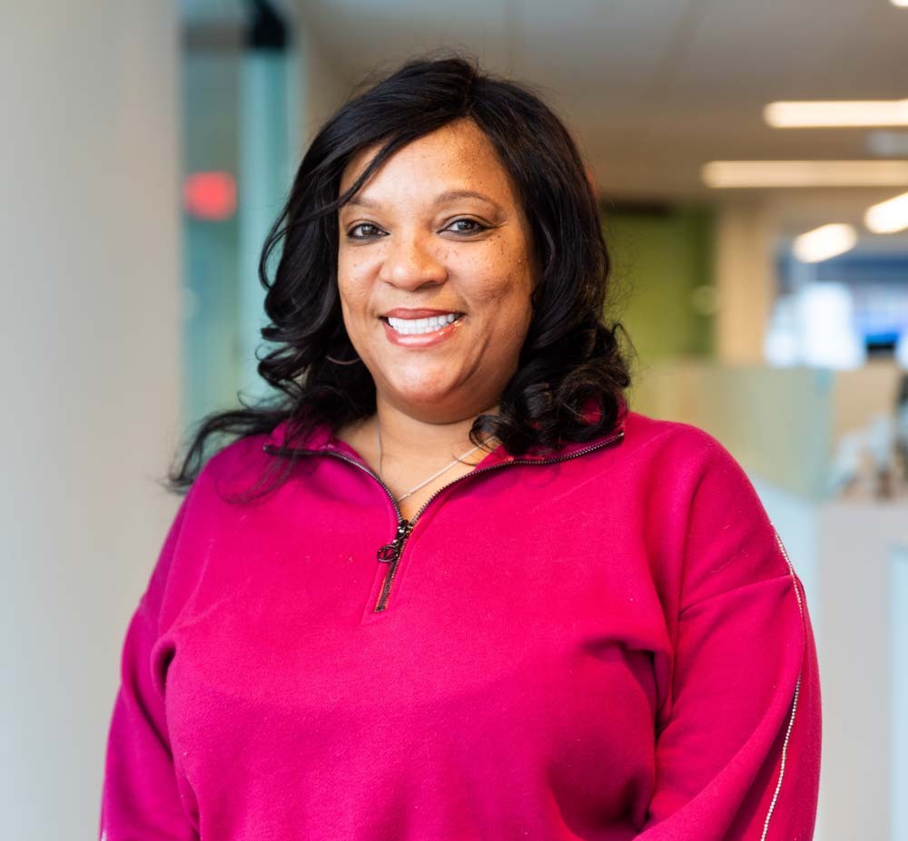Portrait of Rolanda "Vicky" Washington smiling in an office setting.