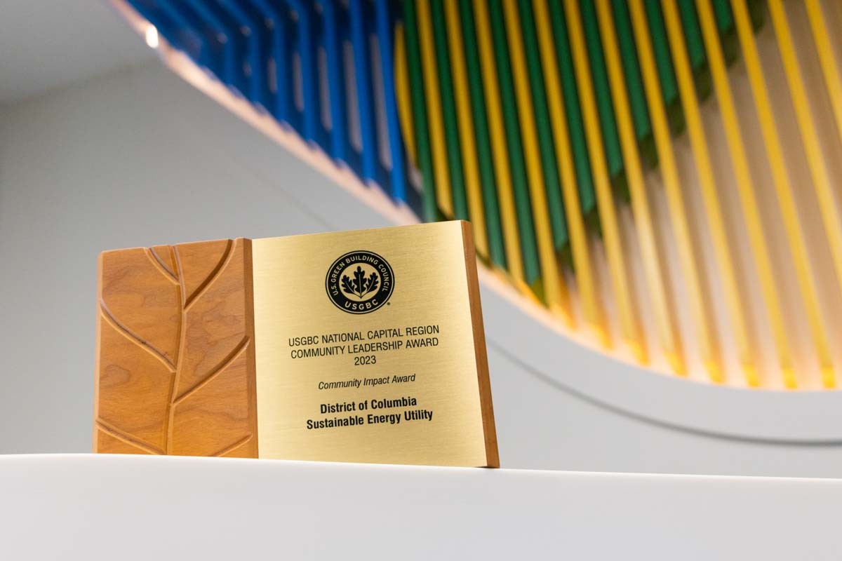 USGBC award plaque in front of the DCSEU logo.