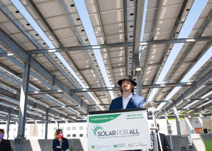 New Columbia Solar CEO, Mike Healy, provides remarks under the Children's National Research and Innovation Campus parking lot solar canopy.
