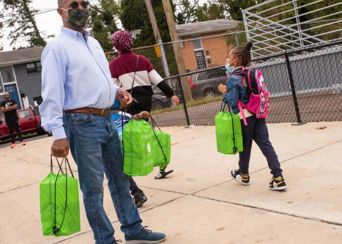 Then DCSEU managing director, Ted Trabue, passing out lighting kits to Plummer Elementary School student.