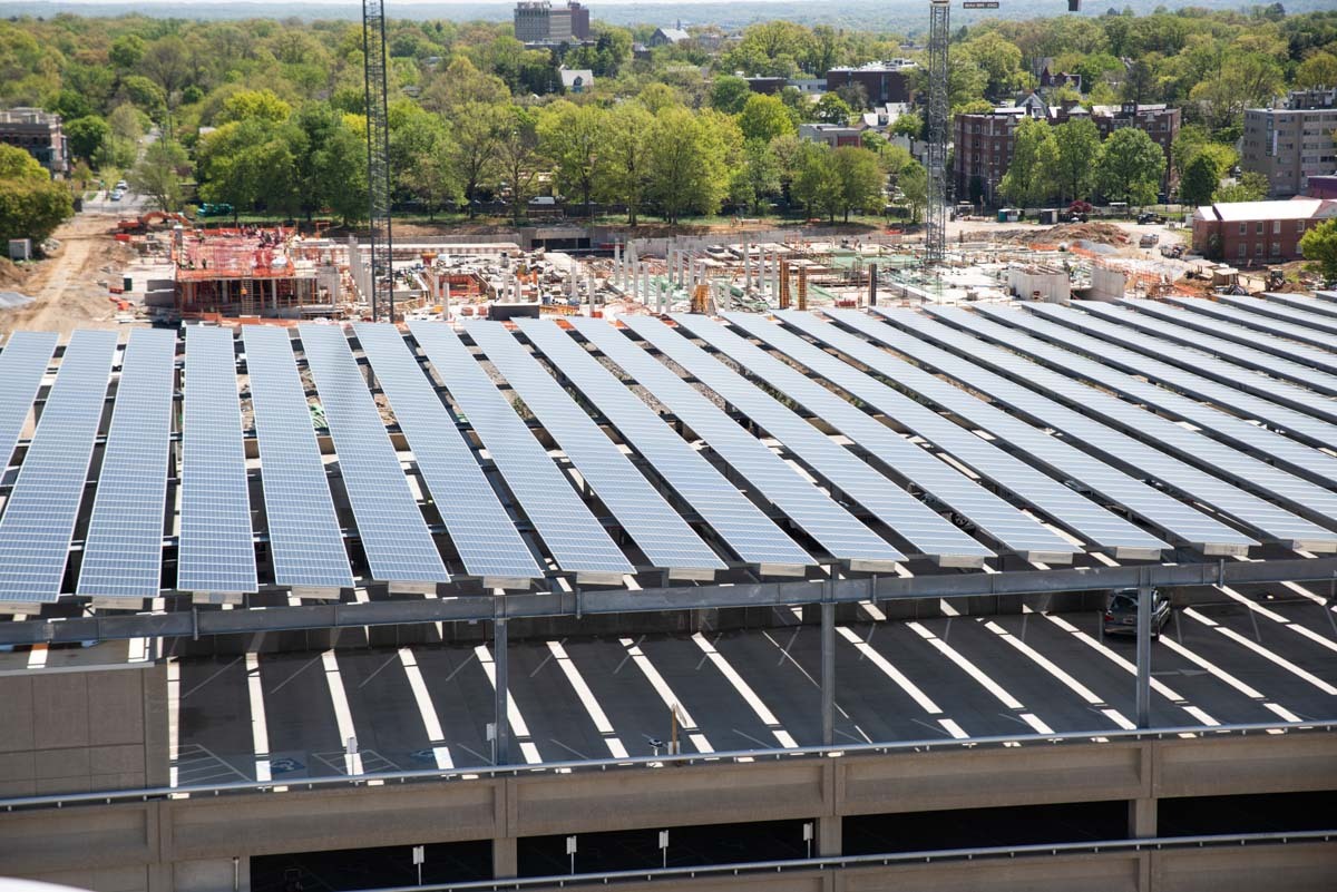Aerial view of a large solar canopy in Ward 4, DC with construction in the background.