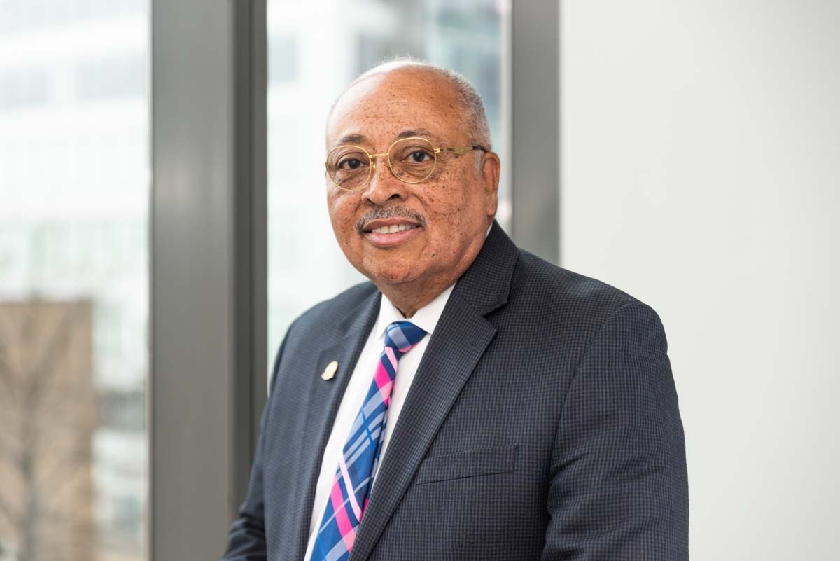 Portrait of new director smiling in an office setting.