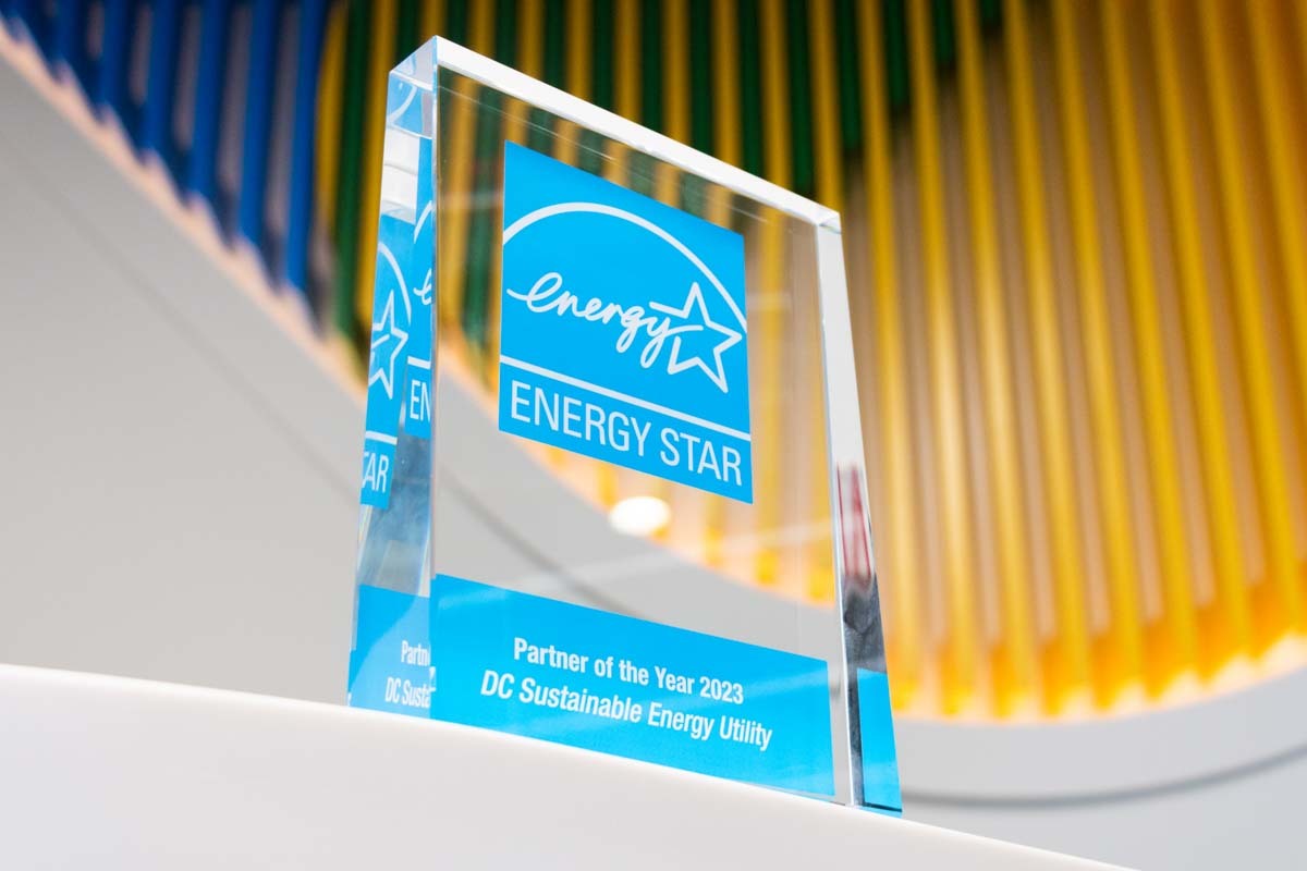 Glass ENERGY STAR award sitting in front of the DCSEU logo.