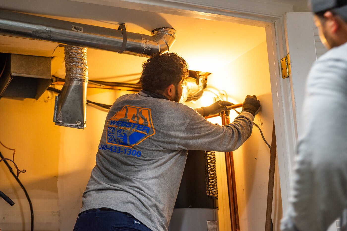 HVAC tech connecting a heat pump water heater.