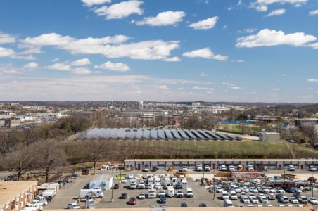 Aerial view of a ground mounted solar system in Ward 5 with the DC skyline visible.