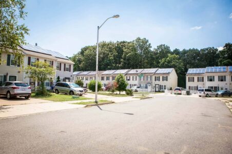 A residential street in the Skyland neighborhood of DC with townhomes that all have solar panels.