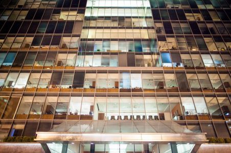 Nighttime view of a DC commercial building facade with all the office lights on.