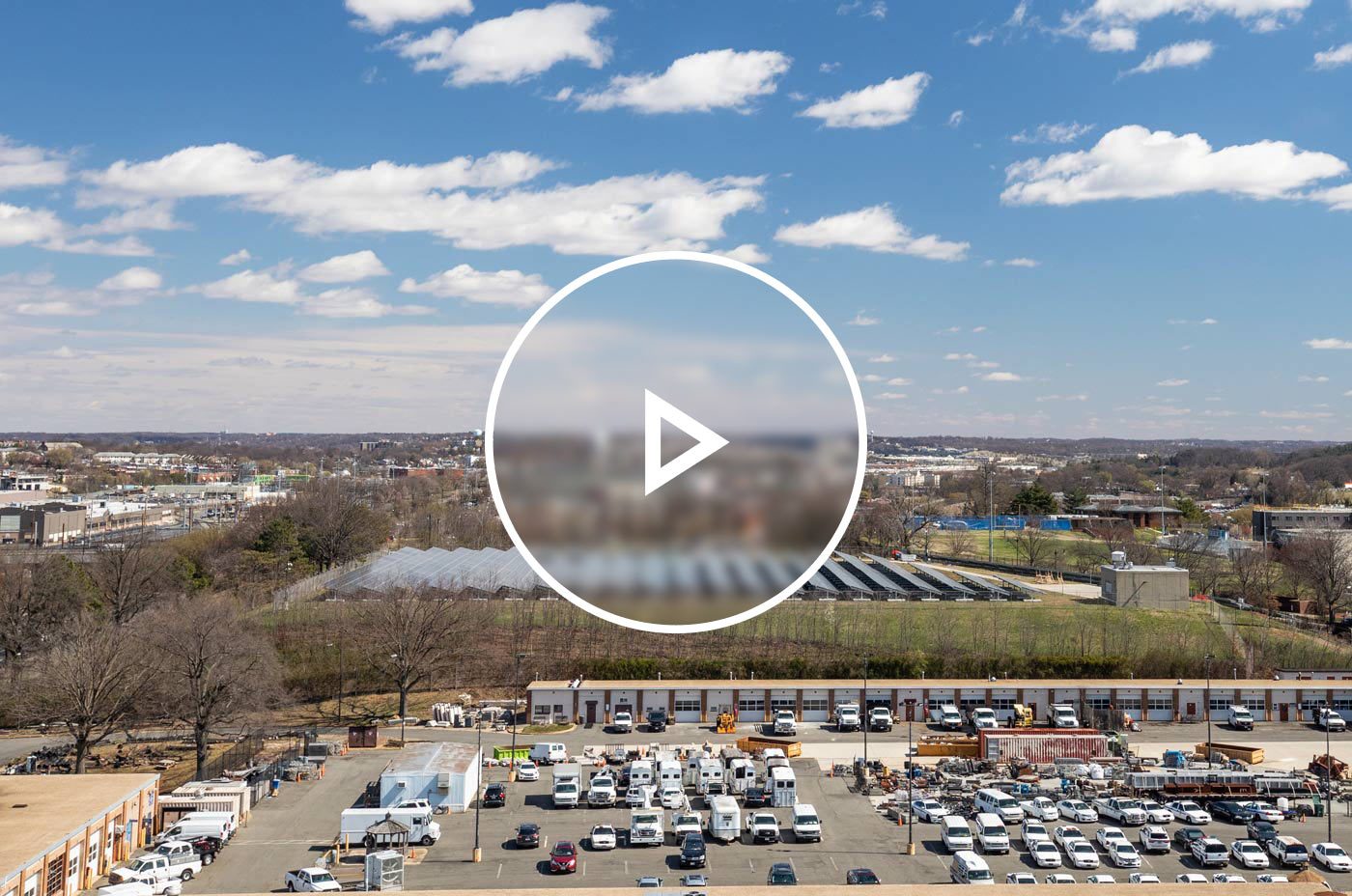 Aerial view of a ground mounted solar system in Ward 5 with the DC skyline visible.