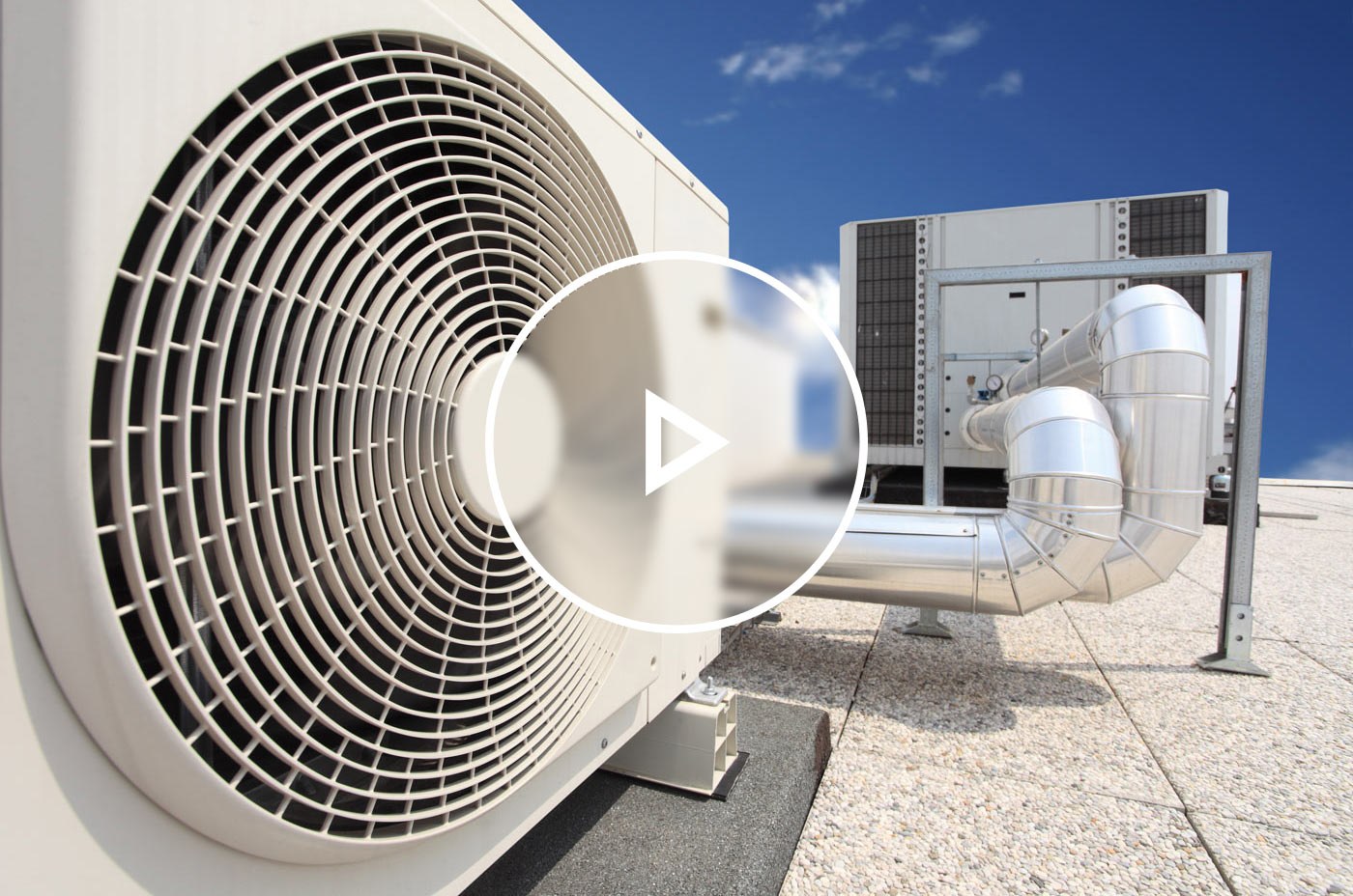 Commercial building rooftop ventilation and pipes for heating and cooling.