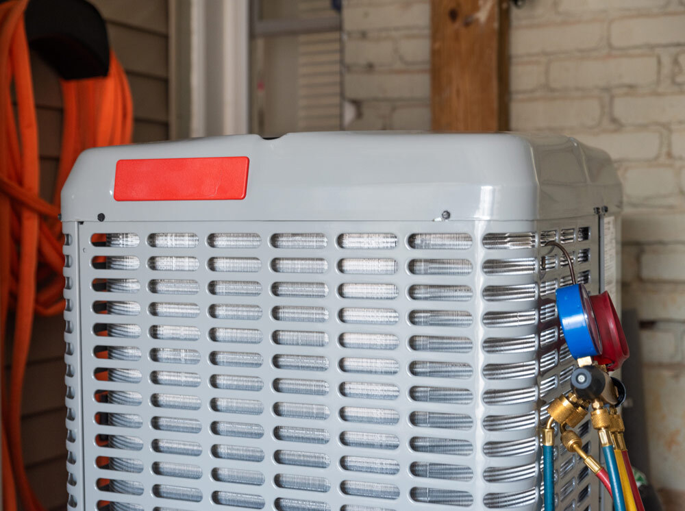 Closeup of a heat pump compressor.